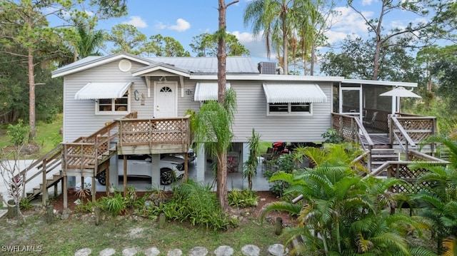 view of front facade featuring a carport and a sunroom