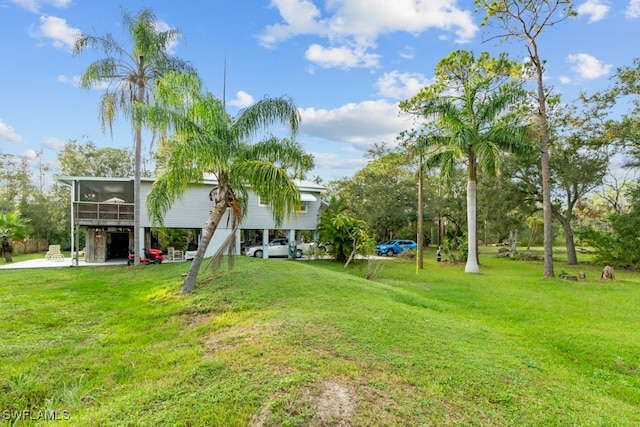 view of yard with a carport and a sunroom