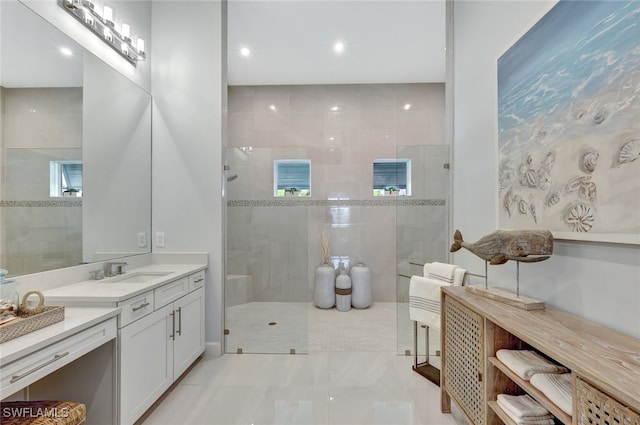 bathroom featuring tiled shower and vanity