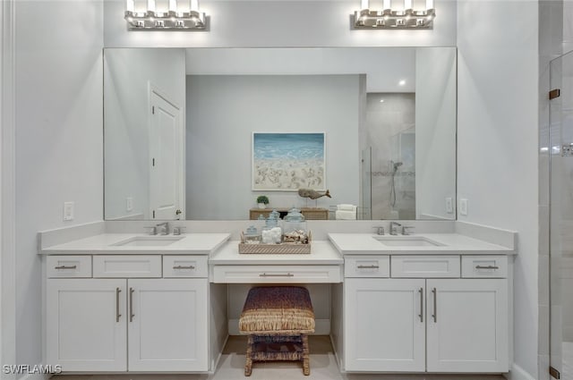 bathroom featuring a shower with door and vanity