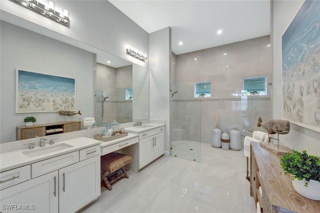 bathroom featuring tile walls, tiled shower, and vanity