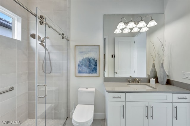 bathroom featuring an enclosed shower, vanity, and toilet