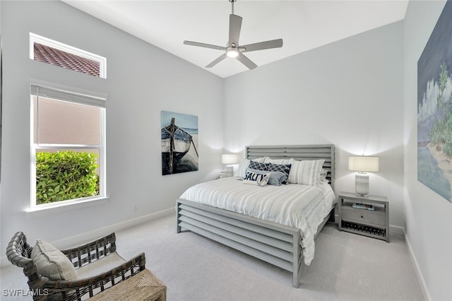 carpeted bedroom with ceiling fan and multiple windows