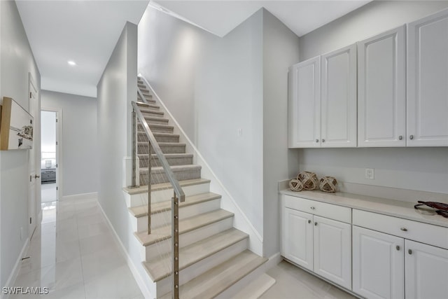 stairway with tile patterned flooring