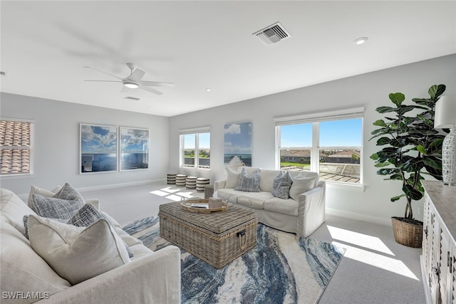 carpeted living room featuring ceiling fan