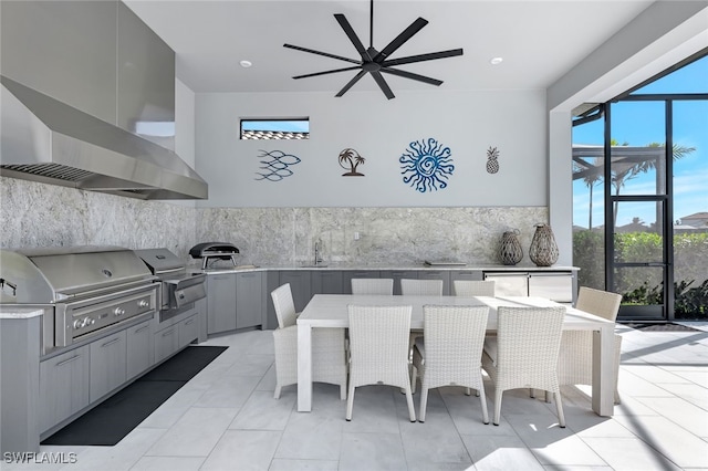 tiled dining area featuring ceiling fan and sink