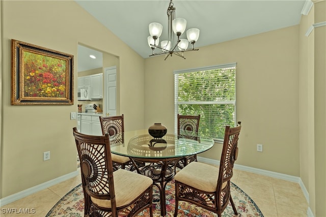 tiled dining room with vaulted ceiling and a notable chandelier