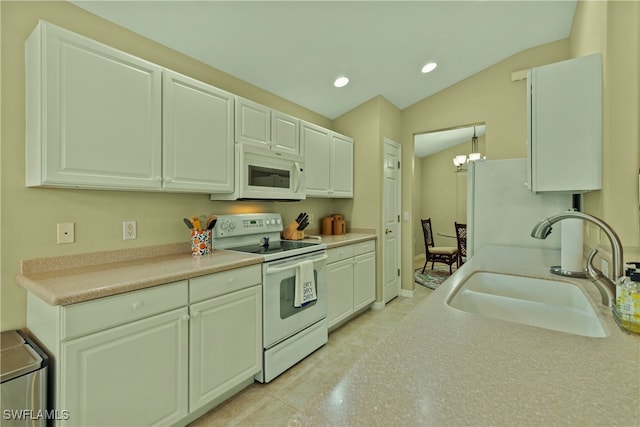 kitchen featuring white cabinets, lofted ceiling, sink, and white appliances