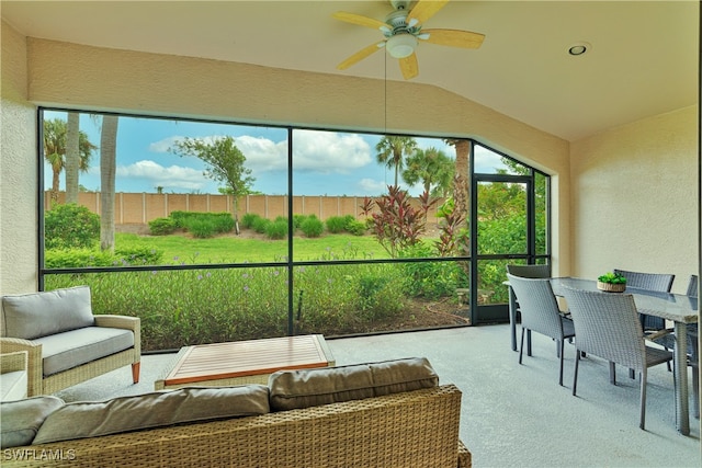 sunroom featuring lofted ceiling and ceiling fan