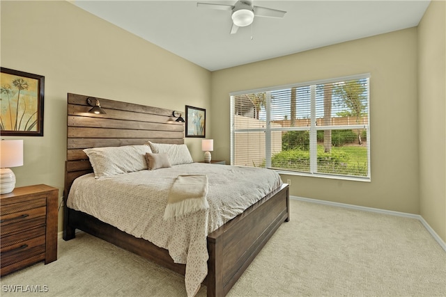 bedroom with light carpet and ceiling fan