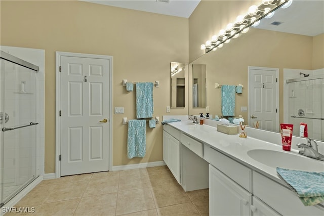 bathroom with vanity, a towering ceiling, tile patterned flooring, and a shower with door