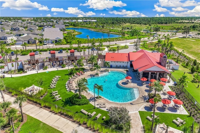 view of swimming pool featuring a water view and a patio area