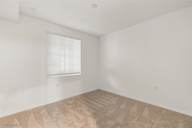 unfurnished room with light carpet