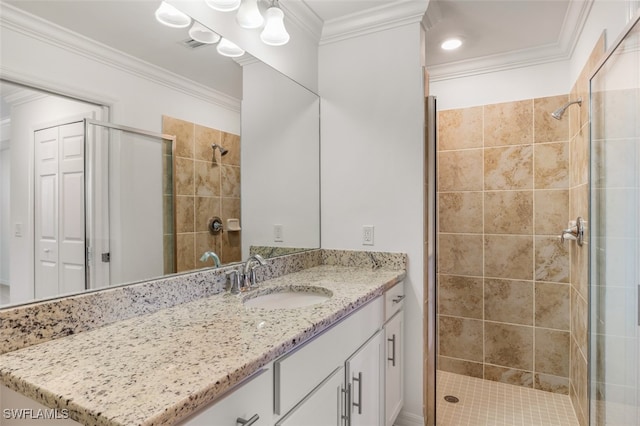 bathroom featuring walk in shower, vanity, and crown molding