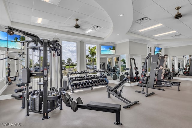 exercise room with ceiling fan, crown molding, and a paneled ceiling