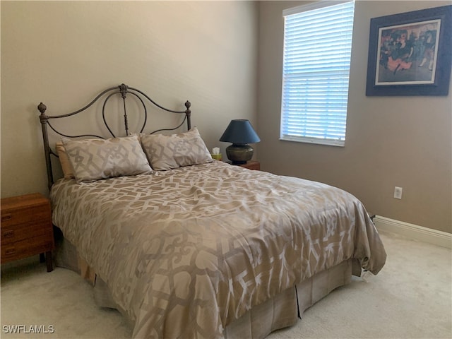 bedroom featuring light carpet