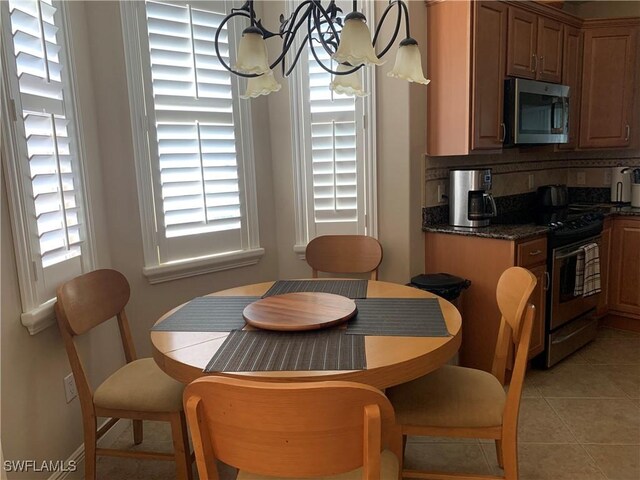 tiled dining area featuring a notable chandelier