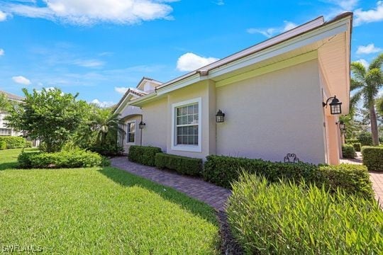 view of property exterior with a yard