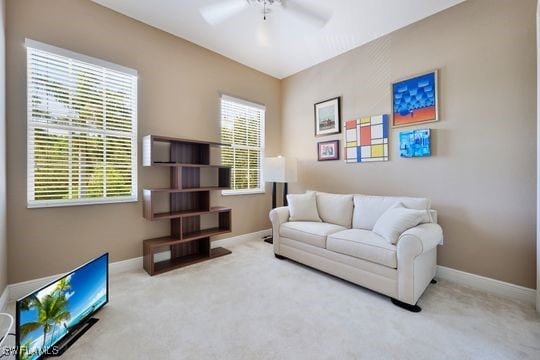 carpeted living room with ceiling fan and plenty of natural light