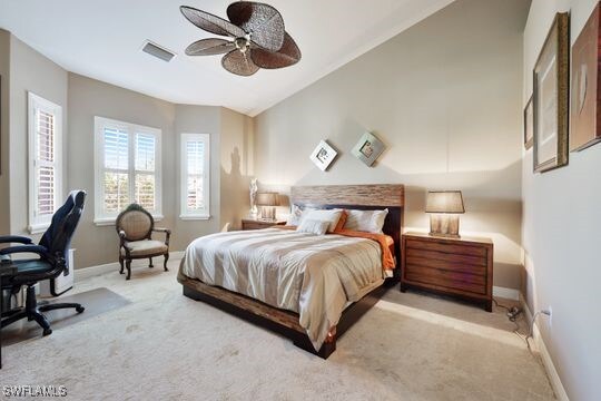 bedroom featuring vaulted ceiling, ceiling fan, and light colored carpet