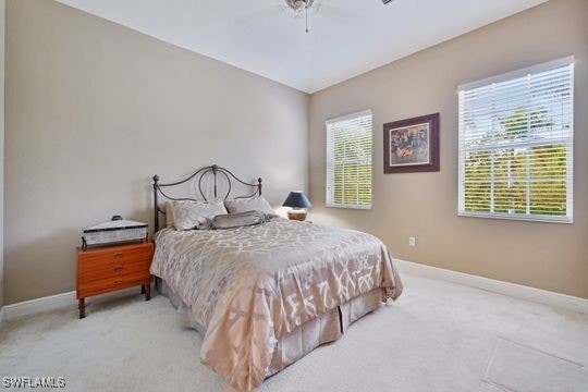 bedroom with ceiling fan and light carpet