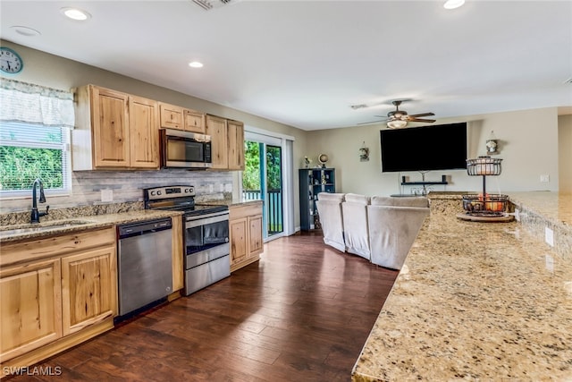 kitchen featuring light brown cabinets, sink, dark wood-type flooring, appliances with stainless steel finishes, and light stone countertops