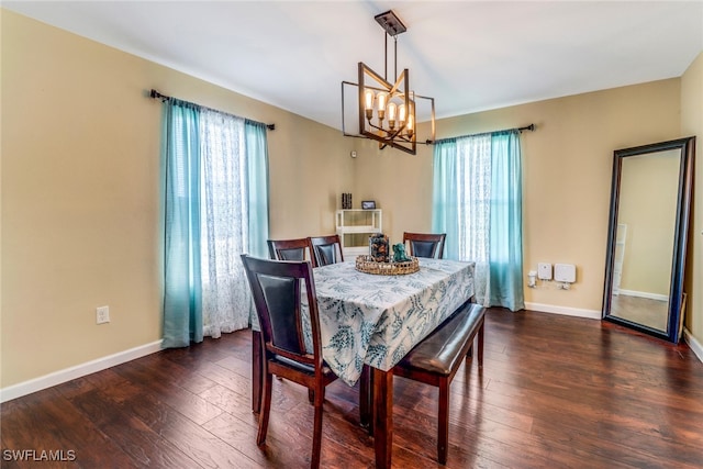 dining space with a notable chandelier, dark hardwood / wood-style floors, and a wealth of natural light