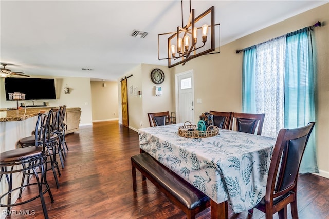 dining room with ceiling fan with notable chandelier and dark hardwood / wood-style floors