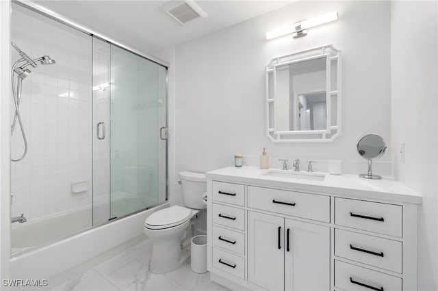 bathroom with marble look tiles, toilet, vanity, and enclosed tub / shower combo