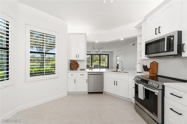 kitchen with stainless steel appliances, a sink, decorative backsplash, and light countertops