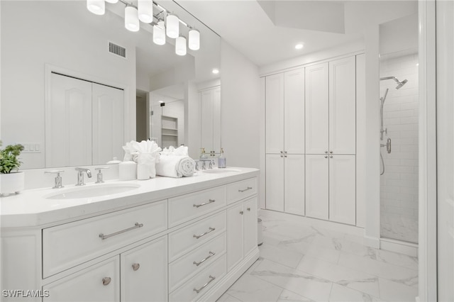 full bathroom featuring a stall shower, marble look tile flooring, double vanity, recessed lighting, and a closet
