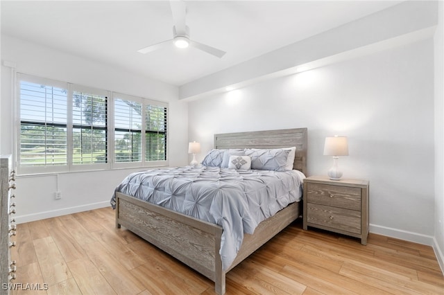 bedroom with light hardwood / wood-style flooring, multiple windows, and ceiling fan