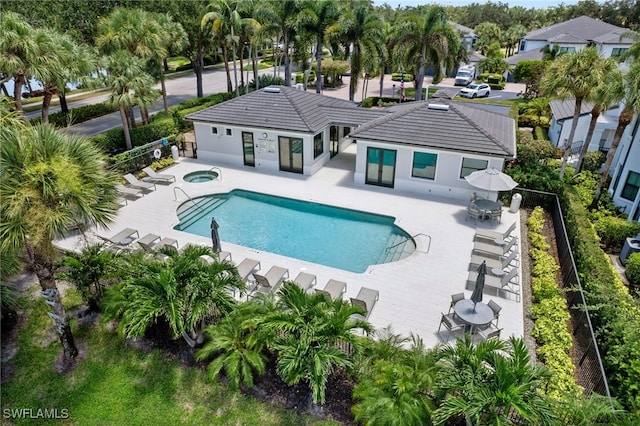 view of pool featuring a hot tub and a patio area