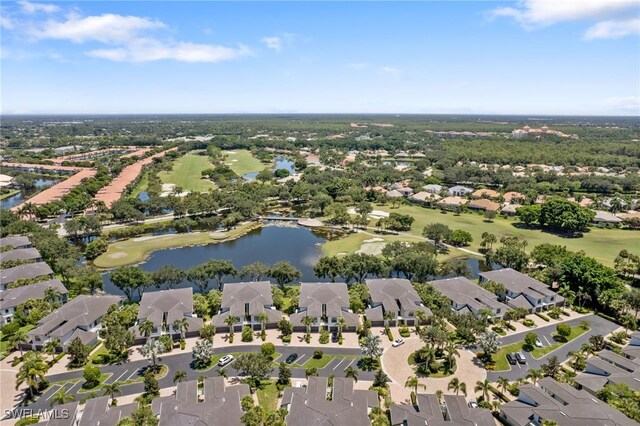view of property location with nearby suburban area, a nearby body of water, and a golf club