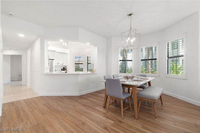 dining area with a chandelier, plenty of natural light, light wood finished floors, baseboards, and recessed lighting