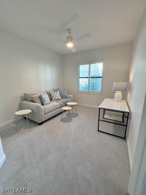 living room featuring ceiling fan and carpet floors