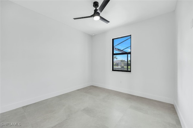 unfurnished room featuring a ceiling fan and baseboards