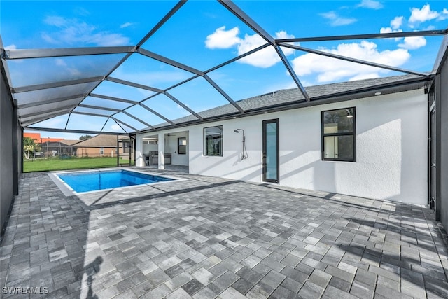 outdoor pool with a lanai and a patio area