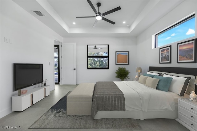 bedroom with a ceiling fan, a tray ceiling, visible vents, and recessed lighting