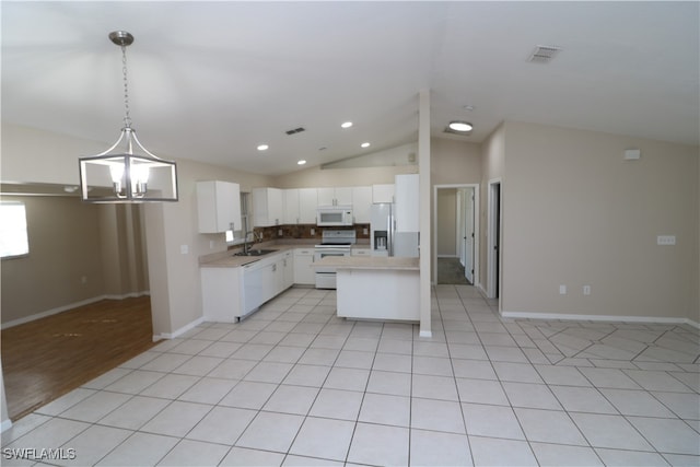 kitchen with a center island, sink, white cabinets, white appliances, and decorative light fixtures