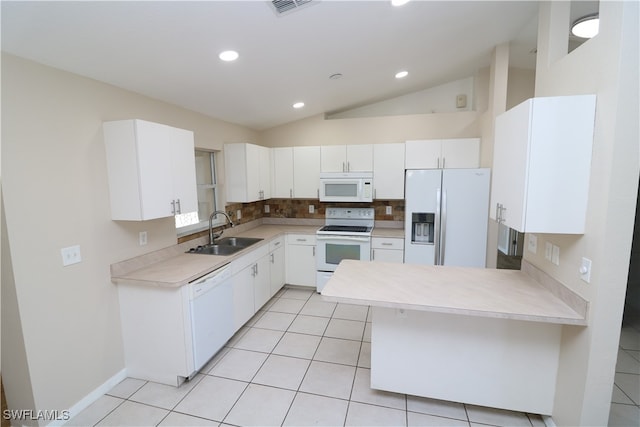 kitchen featuring sink, white cabinets, lofted ceiling, white appliances, and light tile patterned floors