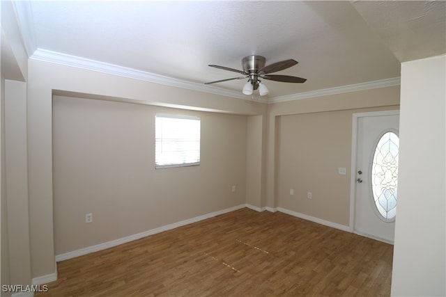 foyer with ceiling fan, hardwood / wood-style flooring, and crown molding