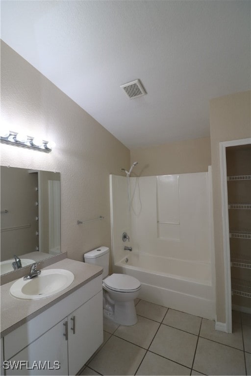 full bathroom featuring tile patterned flooring, shower / bathtub combination, lofted ceiling, vanity, and toilet