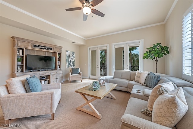 living area with french doors, a ceiling fan, a wealth of natural light, and crown molding