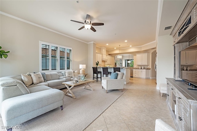 living area featuring arched walkways, visible vents, ornamental molding, a ceiling fan, and light tile patterned flooring