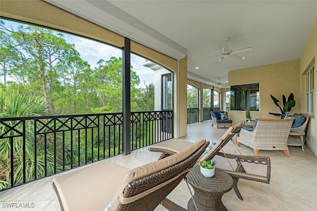 sunroom featuring ceiling fan