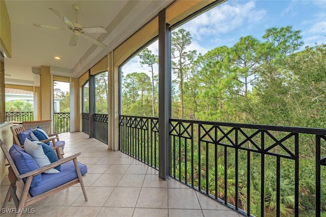 sunroom featuring ceiling fan