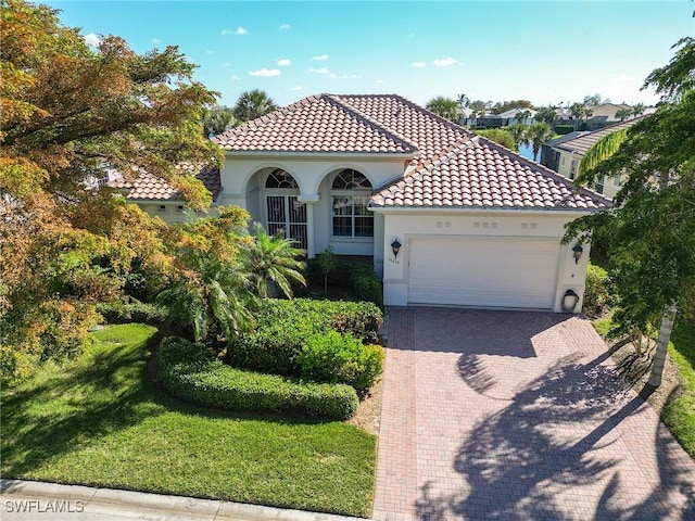 mediterranean / spanish-style house with a garage