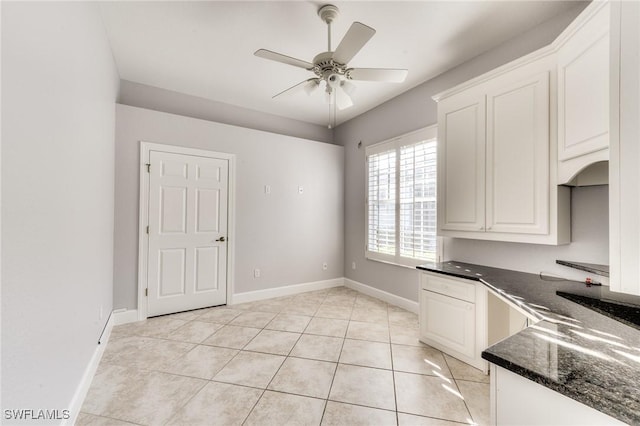 kitchen with white cabinetry, light tile patterned floors, and ceiling fan