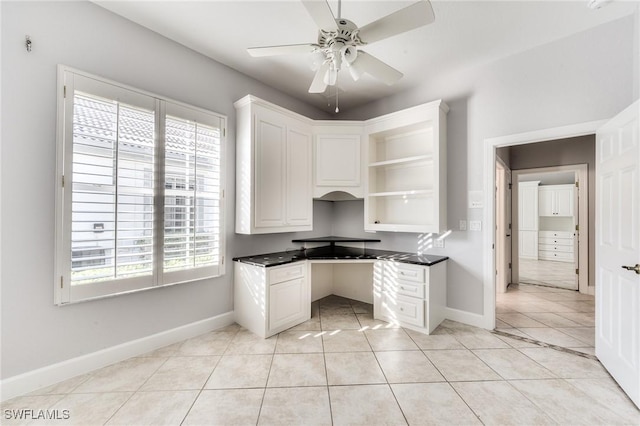 unfurnished office featuring light tile patterned flooring and ceiling fan